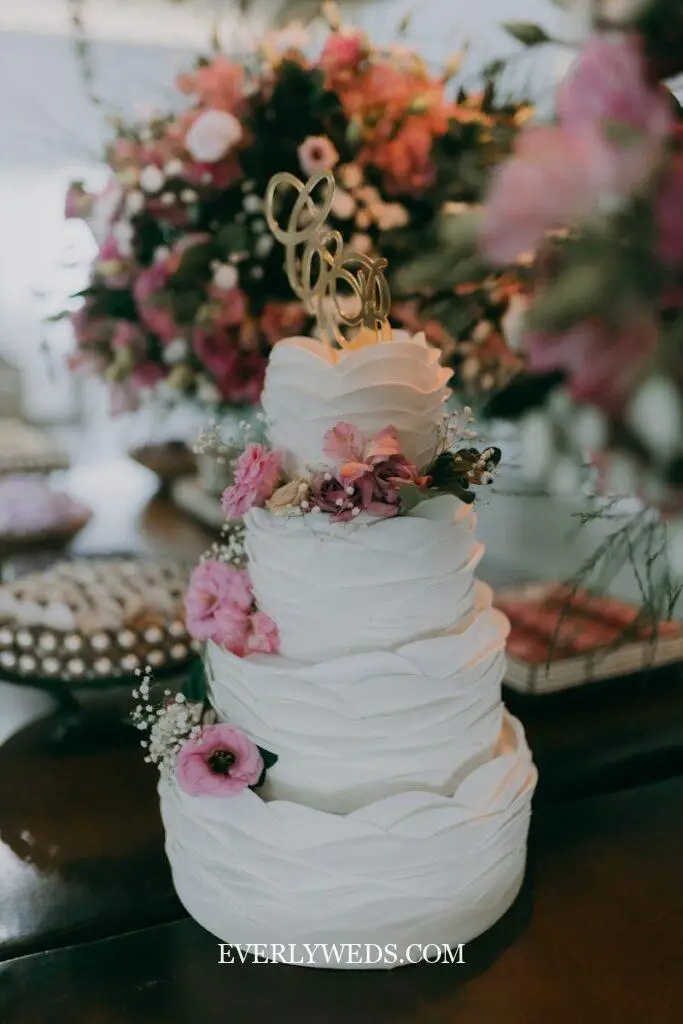 A gorgeous wedding cake with floral decorations.