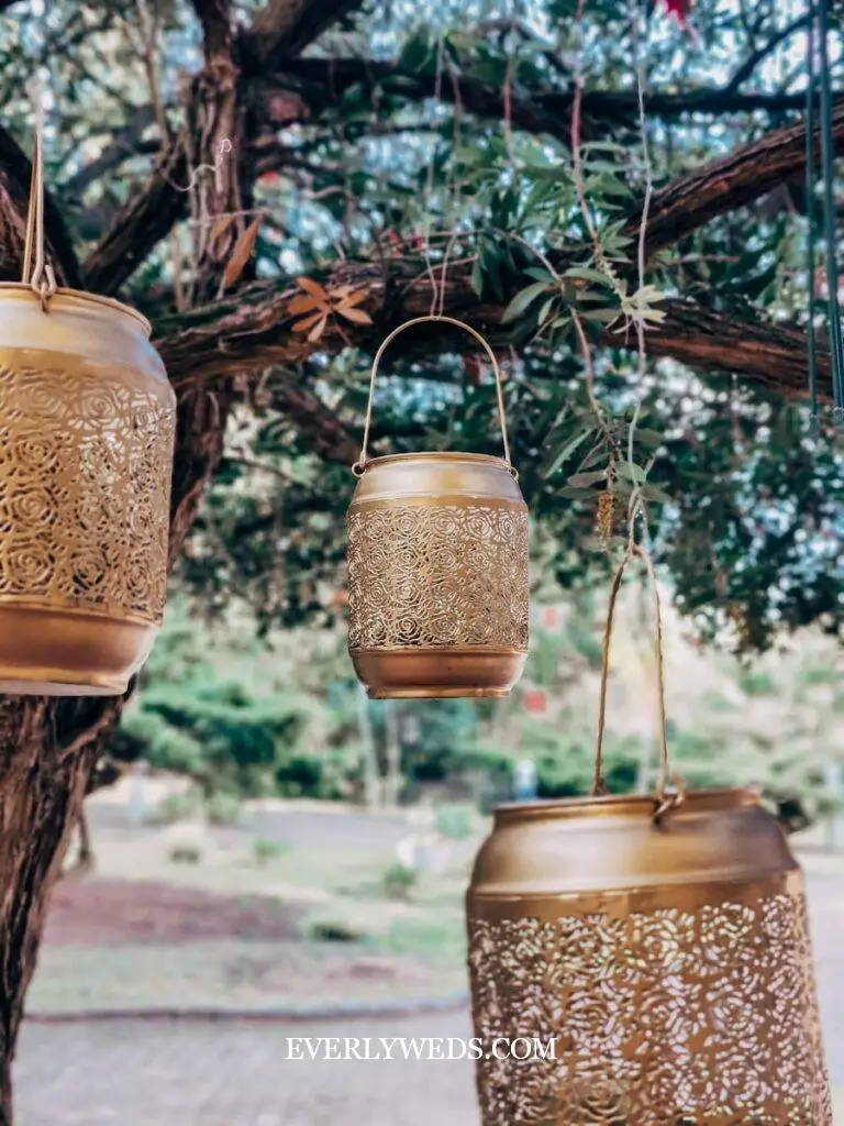 garden theme wedding ceremony walkway lined with lanterns potted succulents enchanted garden backyard wedding outdoor aisle decor