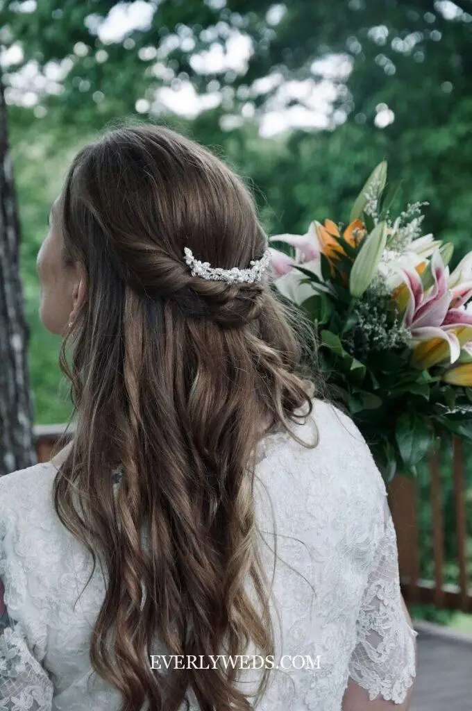 Bride with elegant hairstyle holding a floral bouquet