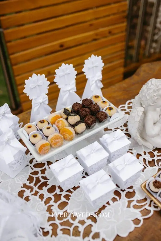 A table topped with lots of desserts on top of a table