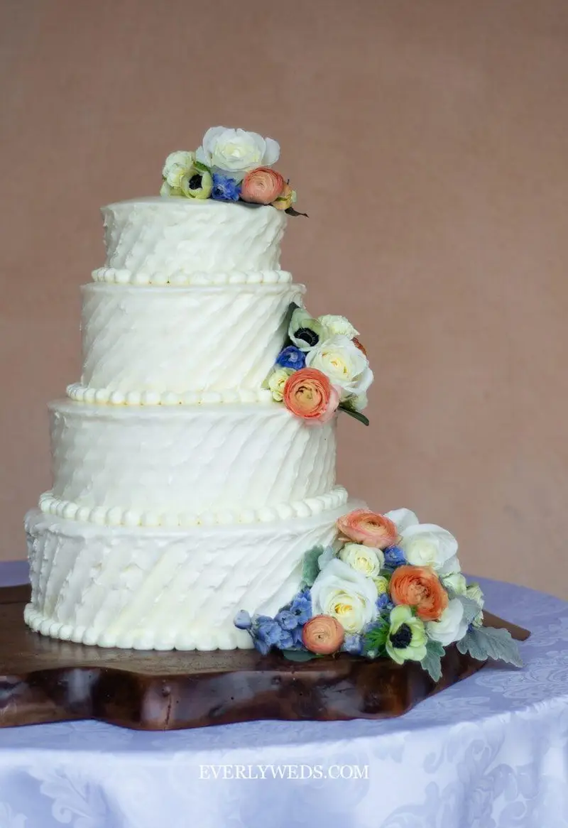 textured buttercream wedding cake design with palette knife finish and simple floral top modern cake design for wedding