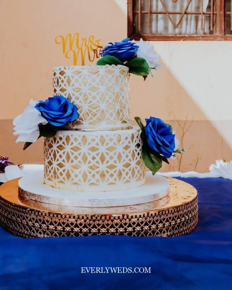 elegant gold wedding cake design with gold leaf accents and white fondant two tier cake
