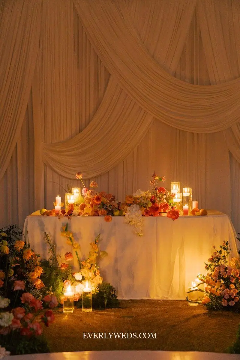 wedding entrance table with sequin backdrop curtain and elegant floral arrangement entryway decor ideas for reception