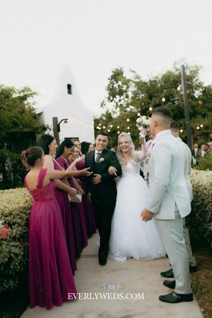 Bride and groom celebrating with wedding party in purple dresses - save the date ideas inspiration