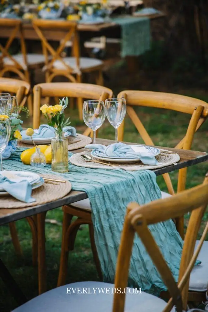 wedding set up table with colorful tablescape flowers candles and linen runner reception decor