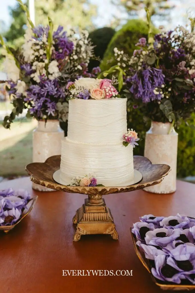Simple wedding cake on a vintage milk glass cake stand at a lakeside rustic wedding reception, simple wedding cake ideas simple and elegant display