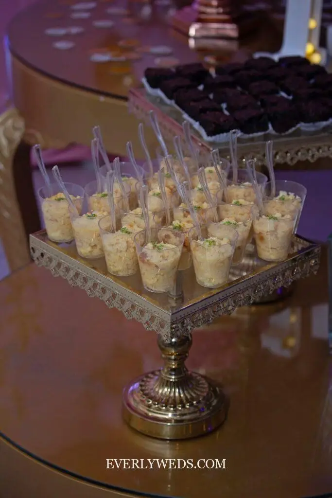 a table topped with a tray of cupcakes