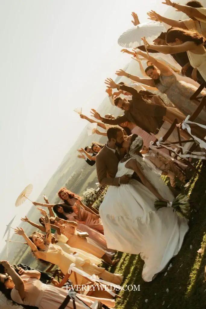 Bride and groom laughing during wedding ceremony exit to unexpected wedding recessional songs while bridal party cheers