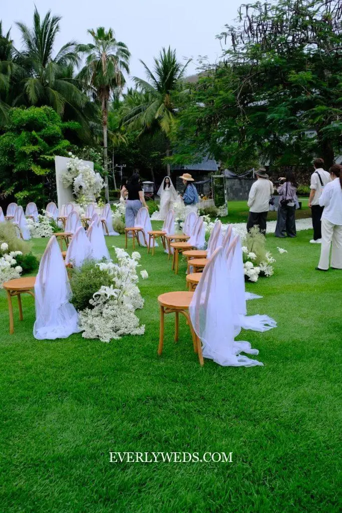 Outdoor wedding ceremony is being set up.