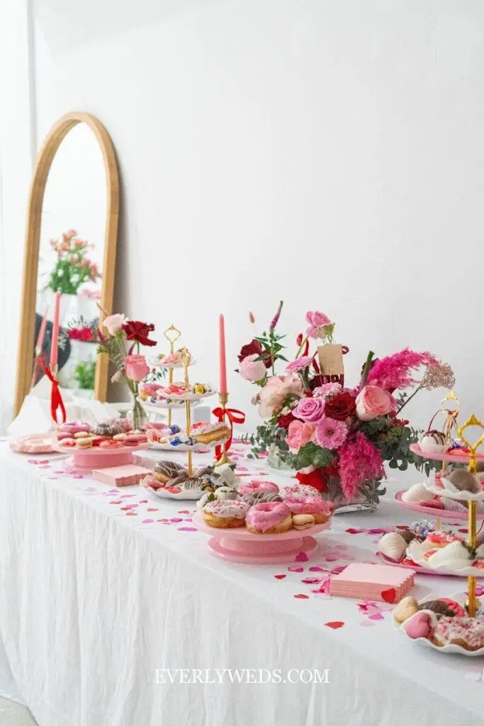 A table topped with lots of desserts and flowers