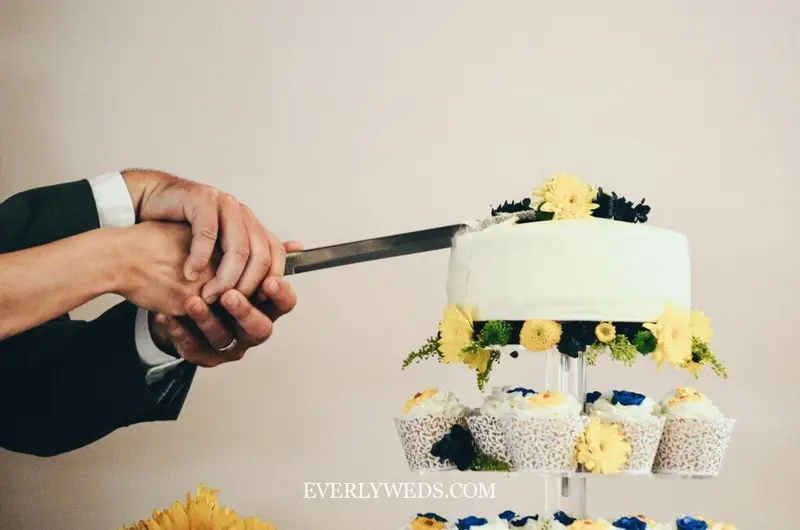 wedding cupcake design display with tiered stand and matching buttercream swirl florals for rustic reception dessert table