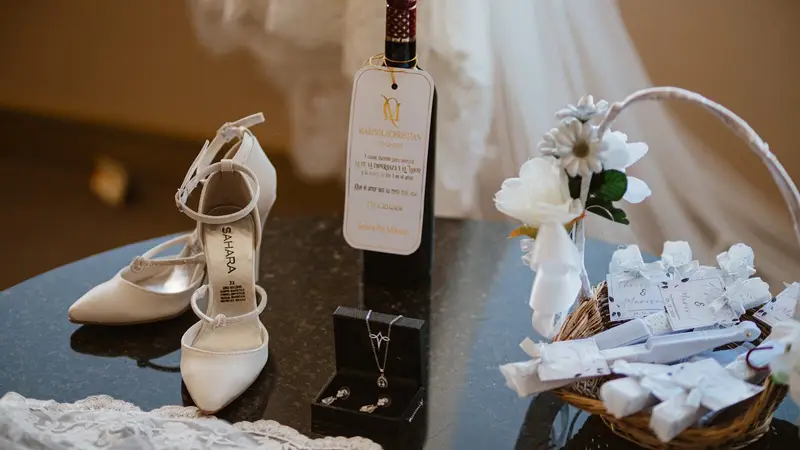 White wedding shoes, jewelry, and flowers arranged flowers