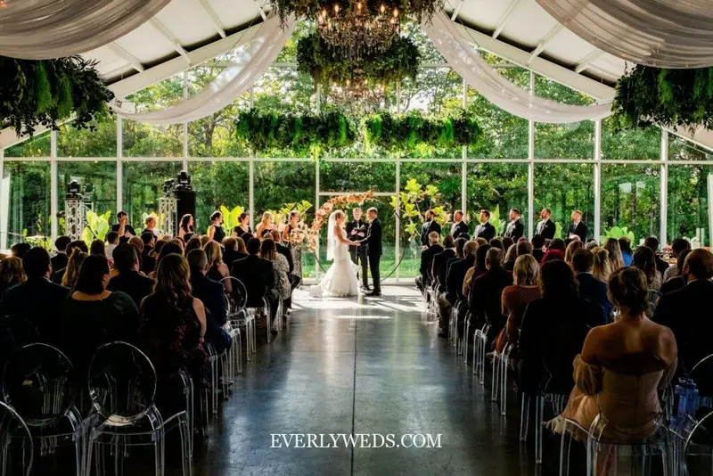 Dream wedding venue outdoors greenhouse garden setting with lush greenery and natural light for modern wedding ceremony