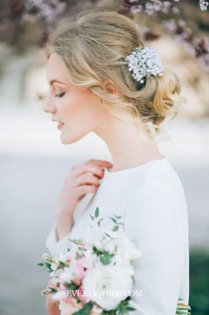 garden theme wedding bride hairstyle with fresh flowers woven into updo boho braid for garden backyard wedding