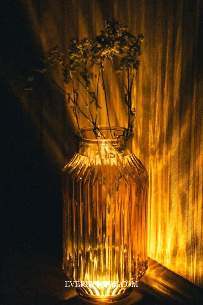 a glass vase with some flowers in it