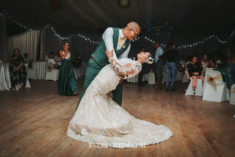 Father daughter wedding dance to rock song at reception with guests watching