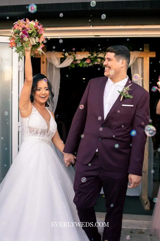 Newlywed couple celebrates with bubbles after ceremony - creative save the date ideas inspiration