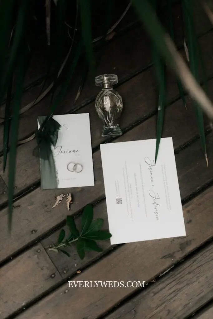Wedding invitation details and a decorative perfume bottle.