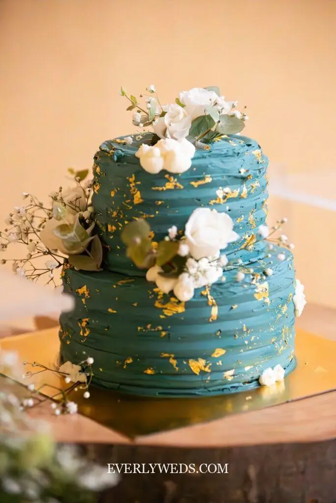 Simple elegant wedding cake with sage green watercolor accent and minimal fresh flowers, simple but elegant wedding cake for a spring outdoor ceremon