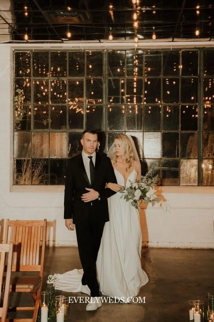 Modern wedding venue ideas indoor with Edison bulb canopy inside a luxury warehouse space