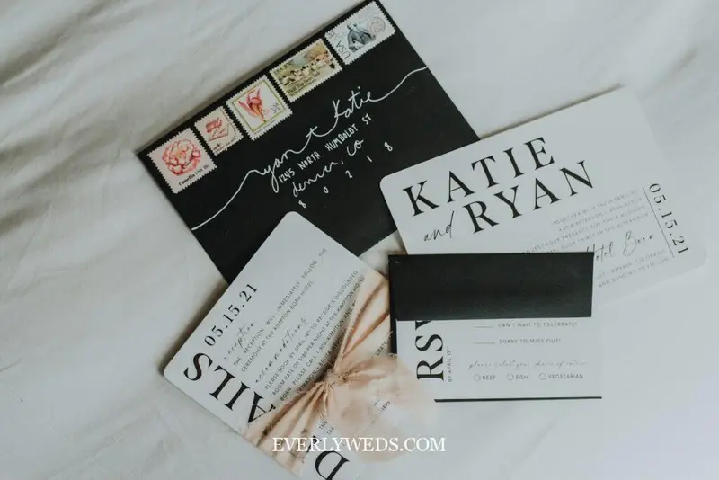 wedding invitation templates being proofread before printing with pen and printed draft copy