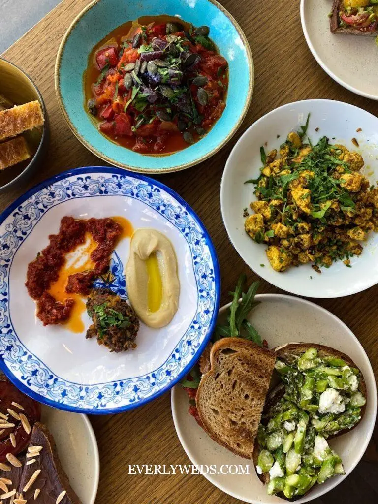 a table topped with lots of plates of food