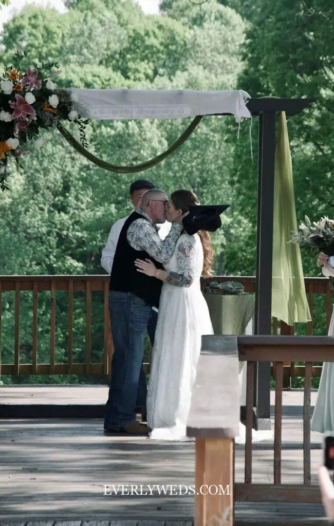 outdoor wedding set up ceremony backdrop with fresh greenery and white florals