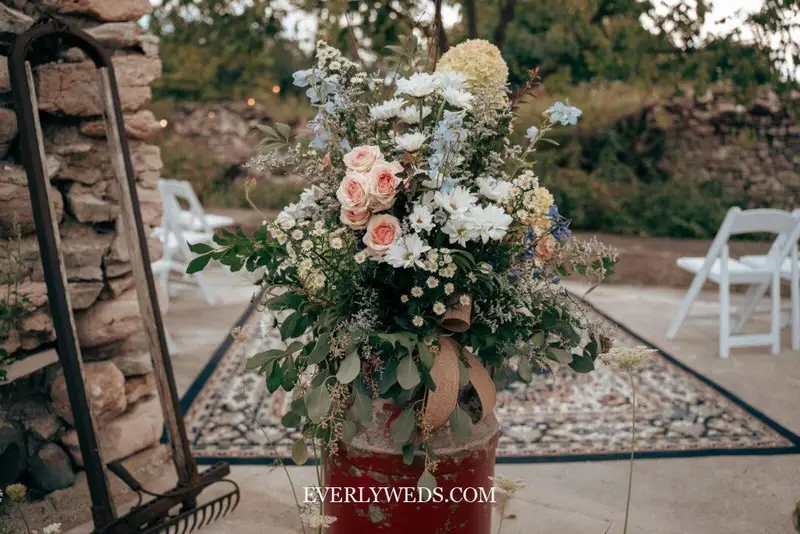 garden theme wedding decorations wildflower centerpiece in vintage vases on reception table with candles