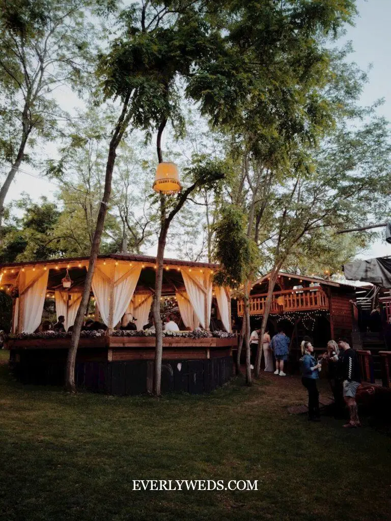 outdoor wedding set up ceremony with tent backup and twinkle lights in case of rain