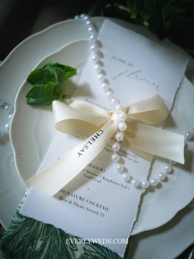 Elegant wedding menu with pearl bracelet and ribbon - creative save the date ideas for couples