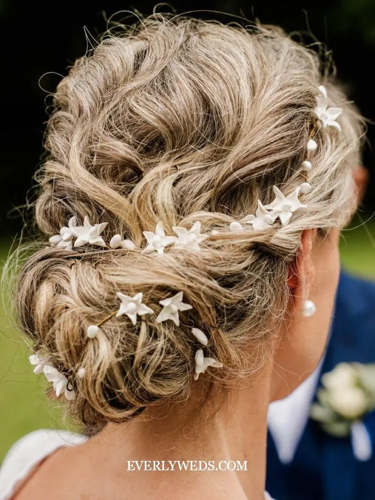 Elegant updo with star and pearl hair accessories